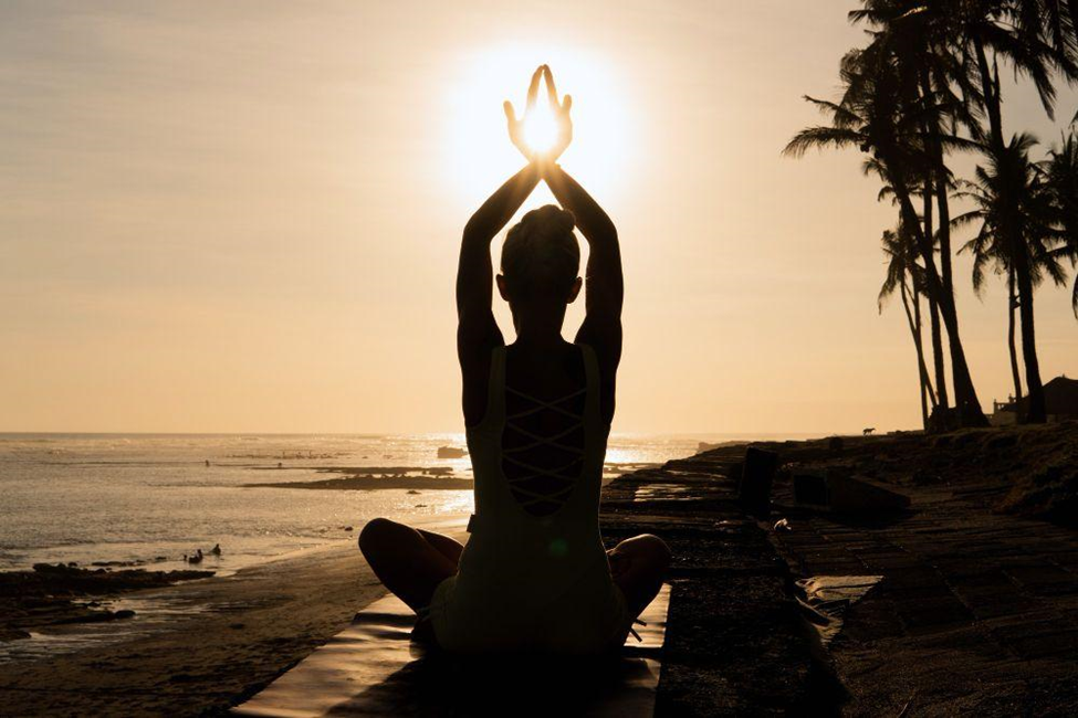 Woman doing yoga outdoors.